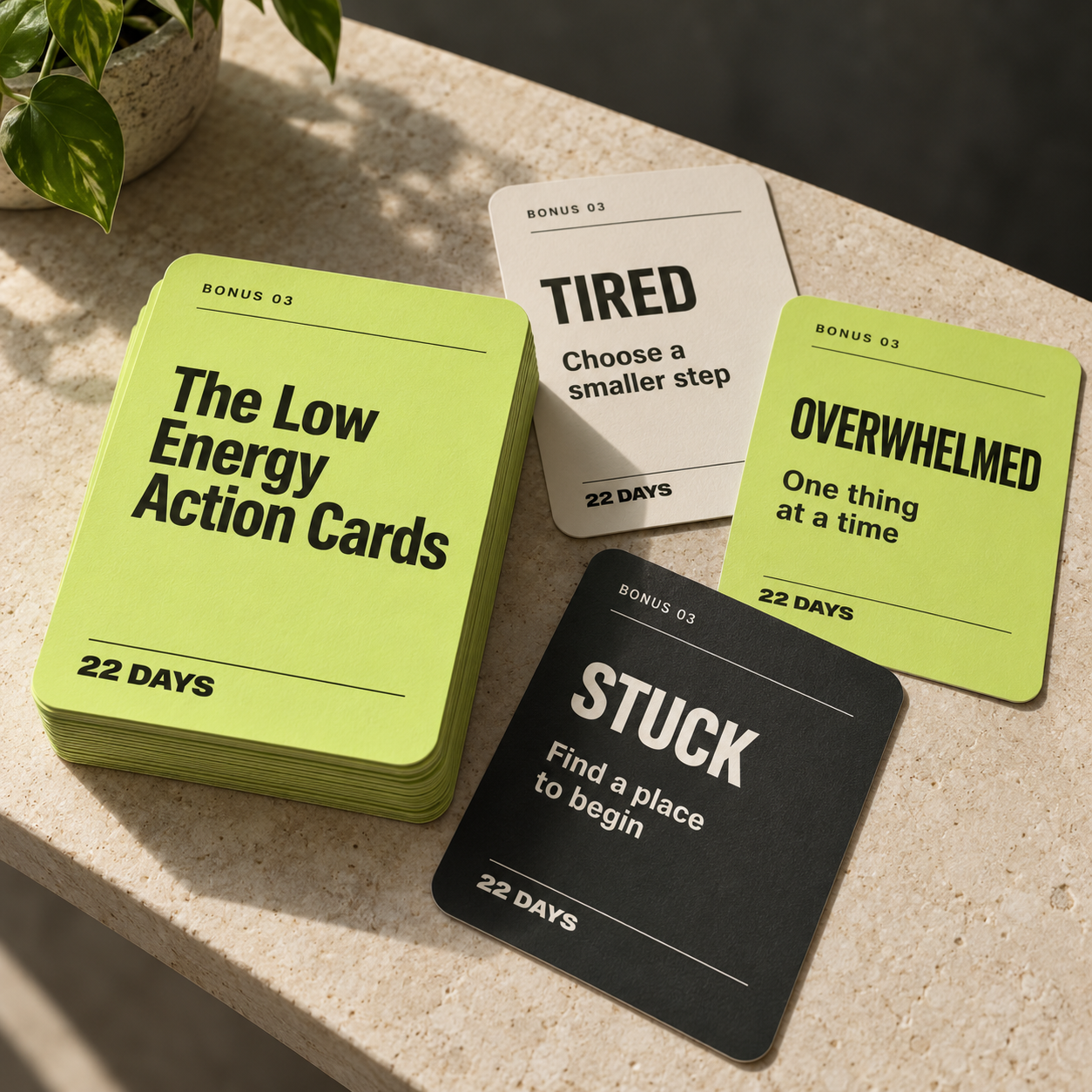 A lime stack of Low Energy Action Cards with separate tired, overwhelmed, and stuck cards fanned beside it.